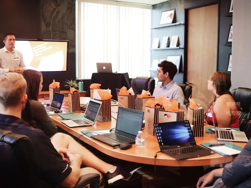 Employees viewing workplace display screen